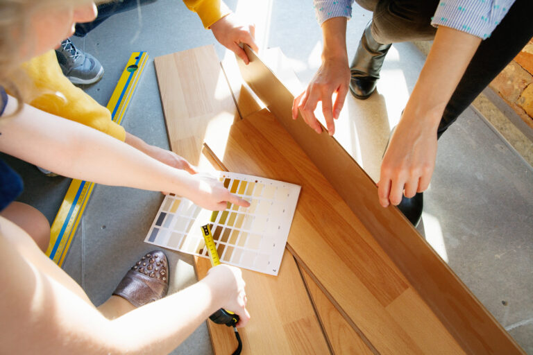 Interior designer working with young couple. Lovely family and professional designer or architector.